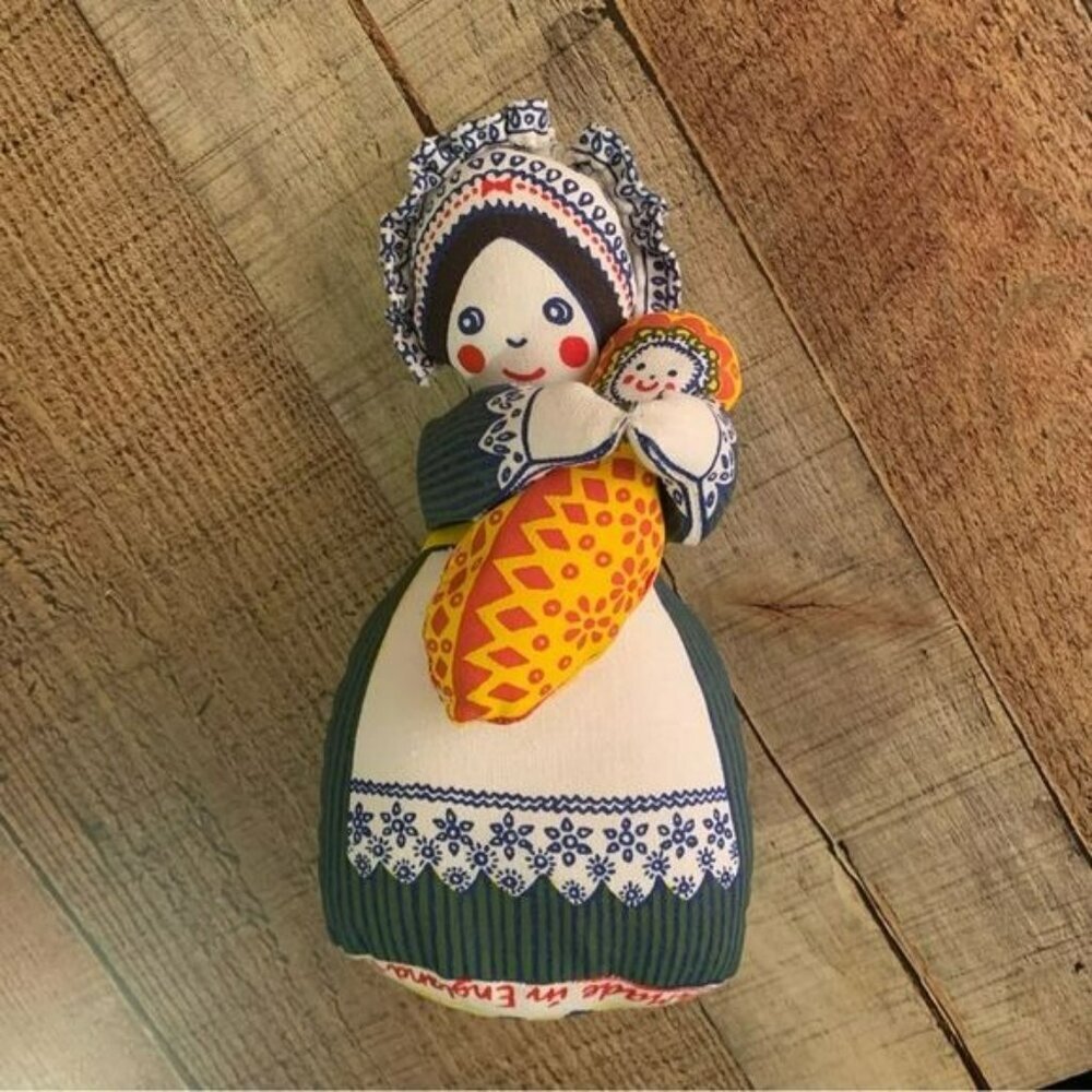 Louise Elliott designs stuffed doll with baby